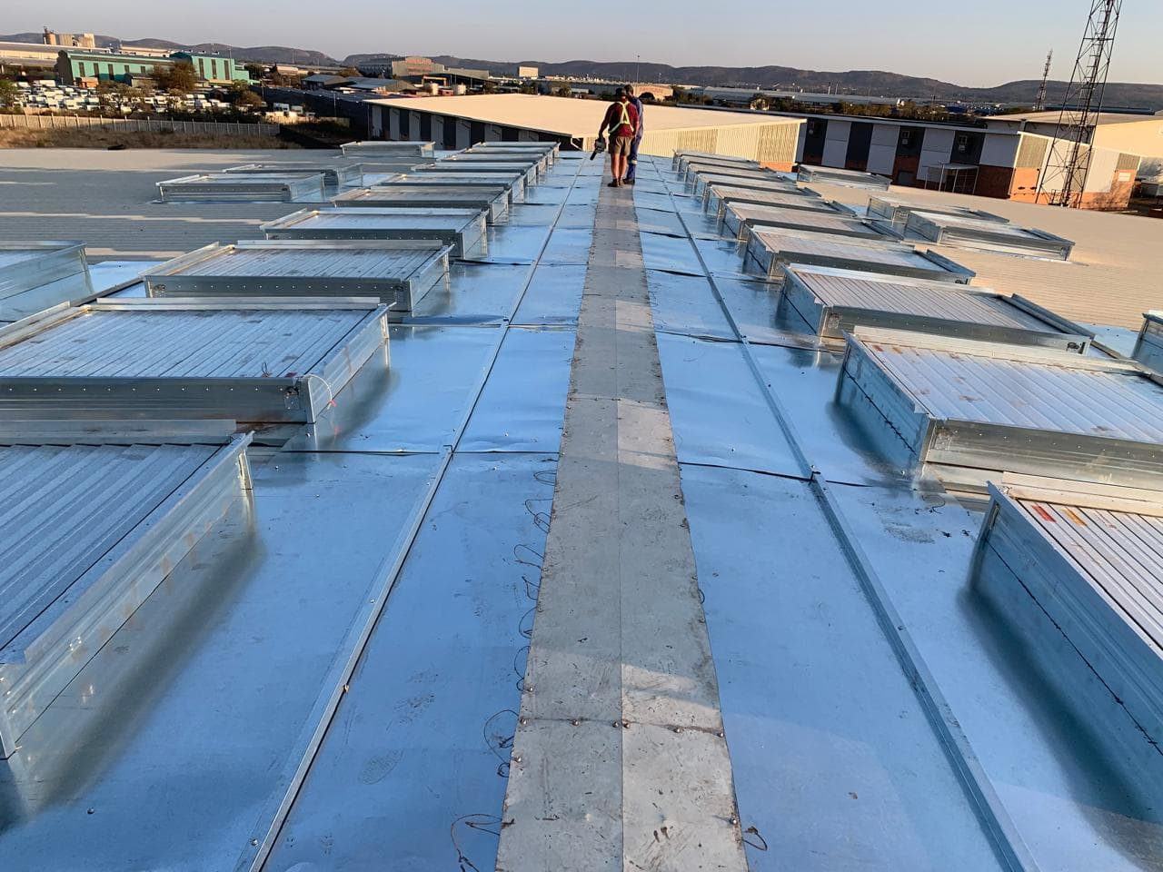 Rows of natural smoke ventilators installed on an industrial roof